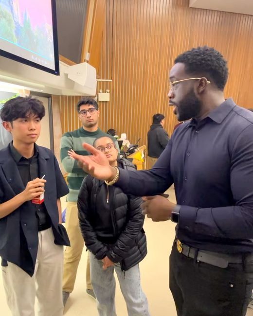 Ezekiel K. Bissah talking with students after the panel