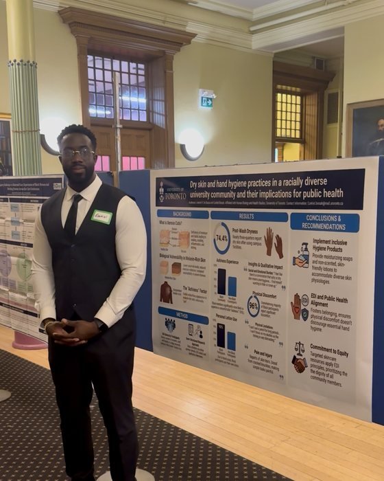 Ezekiel K. Bissah standing beside his research poster at the Black Research Network Symposium
