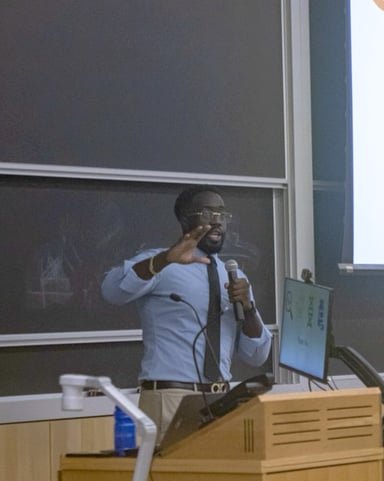 Ezekiel K. Bissah presenting at the podium during the event