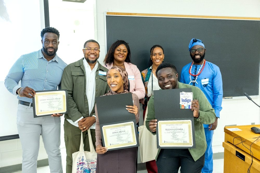 Ezekiel K. Bissah receiving the Poster Presentation Award alongside fellow recipients and symposium organizers